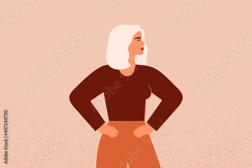 Strong female with hands on her hips looks forward. Confident Businesswoman or entrepreneur in corporate clothing. The concept of gender equality and of the female empowerment movement.