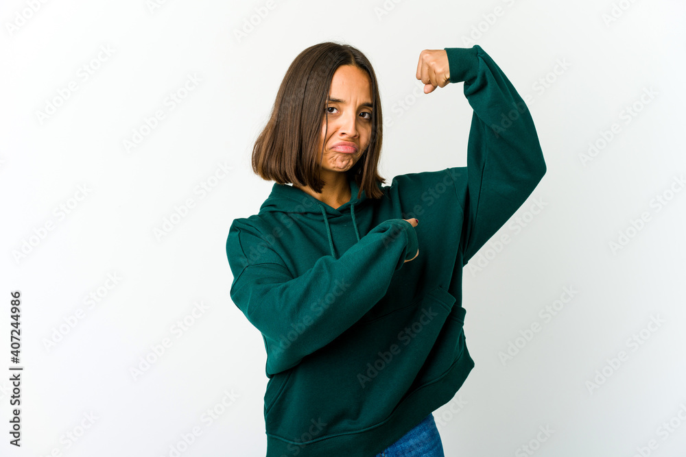 Young mixed race woman showing strength gesture with arms, symbol of power Young mixed race woman showing strength gesture with arms, symbol of power
