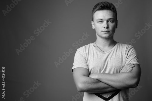 Portrait of young handsome man against gray background