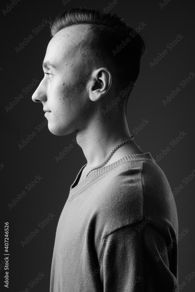Portrait of young handsome man against gray background Portrait of young handsome man against gray background