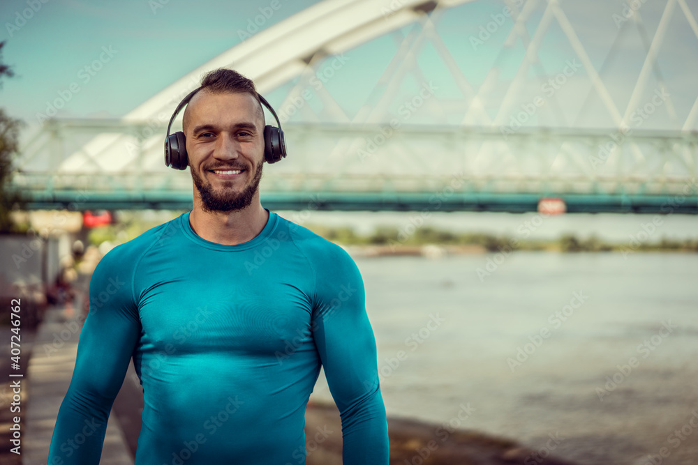 Young handsome man training hard. Man doing sports outside. Outdoors recreation, stretching and training fit body Young handsome man training hard. Man doing sports outside. Outdoors recreation, stretching and training fit body