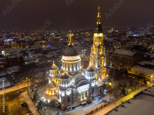 Holy Annunciation Cathedral illuminated in winter snowy night lights. Aerial view Kharkiv city orthodox church sight  Ukraine. Side view from air. Main city landmark
