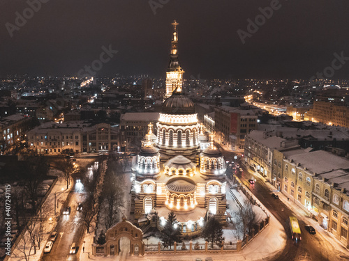 Holy Annunciation Cathedral illuminated in winter snowy evening lights. Aerial view Kharkiv city orthodox church in downtown  Ukraine. Front view from air