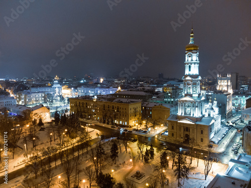 Dormition Cathedral illuminated in winter snowy evening lights. Aerial view Kharkiv city downtown  Ukraine