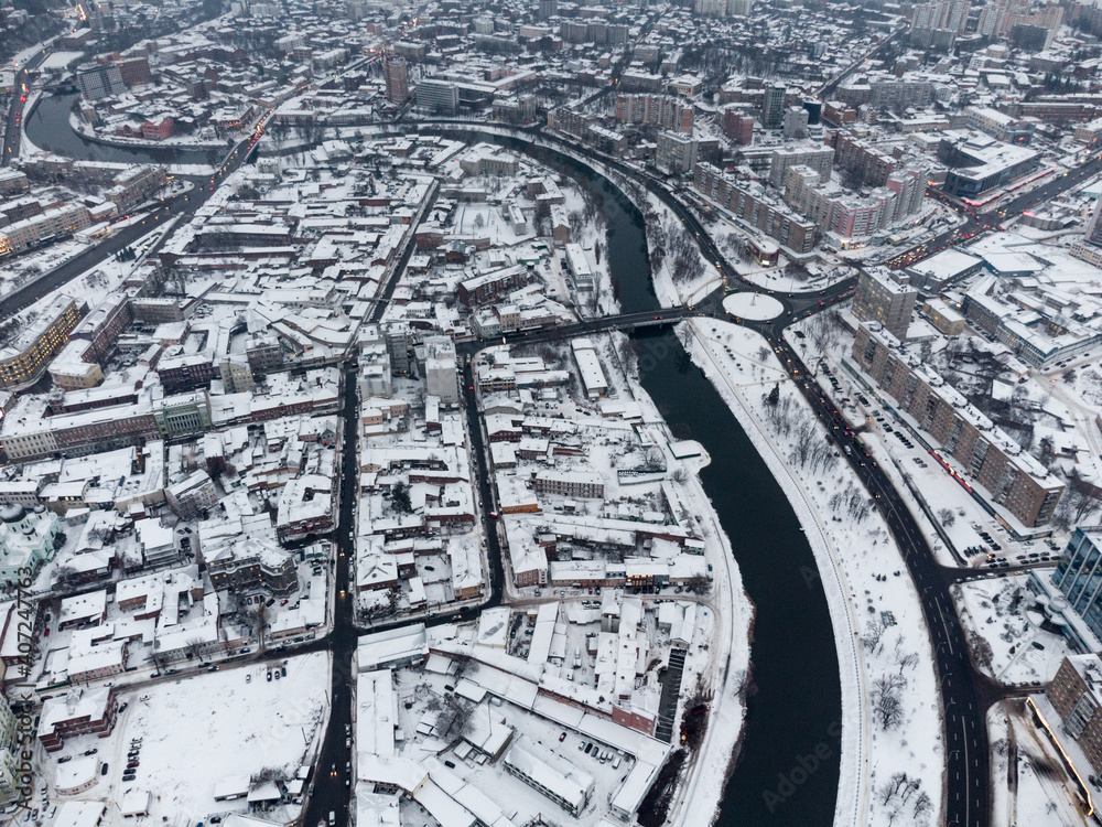 Winter day aerial view to snowy downtown with river black pattern in Kharkiv, Ukraine. Urban city wintery patterns