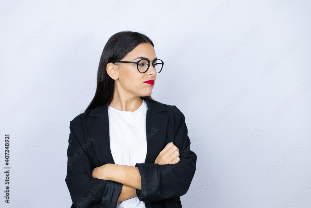 Beautiful business woman thinking looking tired and bored with crossed arms Beautiful business woman thinking looking tired and bored with crossed arms