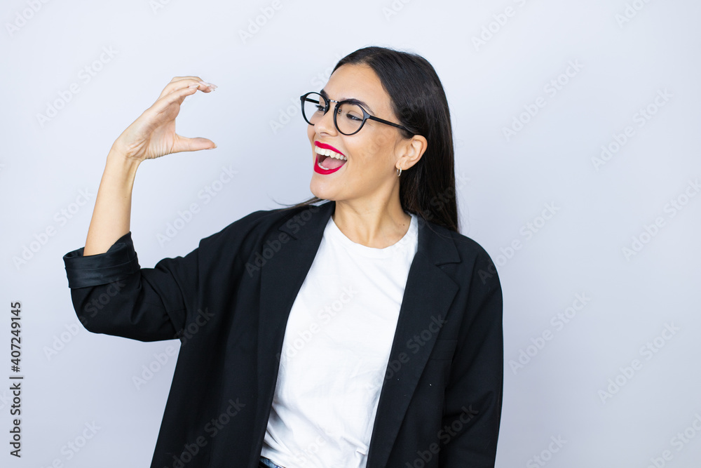 Beautiful business woman smiling and confident gesturing with hand doing small size sign with fingers . Measure concept