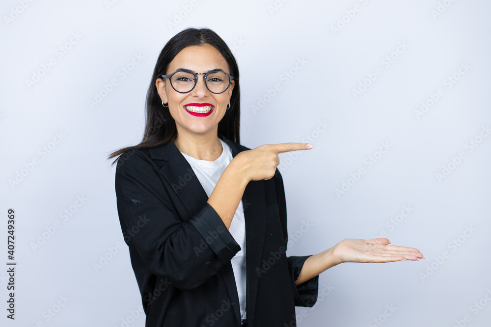 Beautiful business woman showing and pointing something that is on her hand Beautiful business woman showing and pointing something that is on her hand