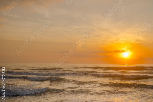 silhouette beach with sunrise and sea background © tickcharoen04