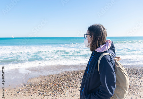 Girl with face mask at the beach