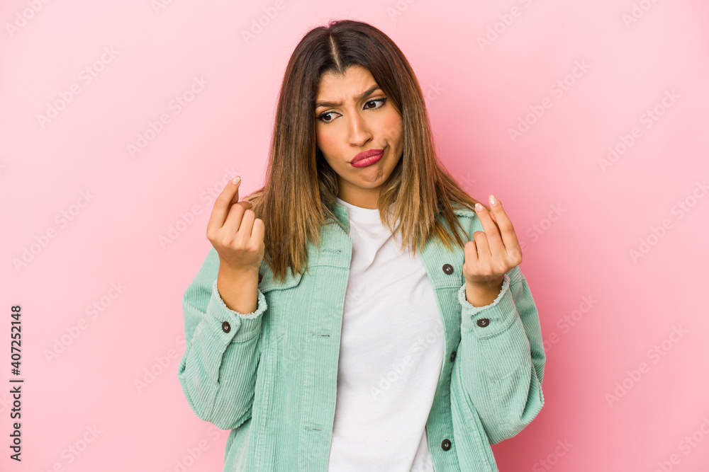 Young indian woman isolated on pink background showing that she has no money. Young indian woman isolated on pink background showing that she has no money.