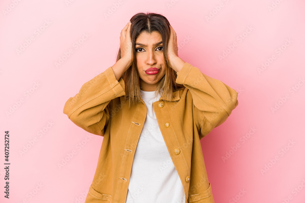Young indian woman isolated on pink background being shocked, she has remembered important meeting. Young indian woman isolated on pink background being shocked, she has remembered important meeting.