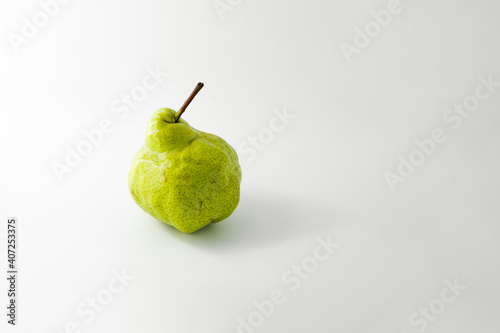 The strange green pear on a white background