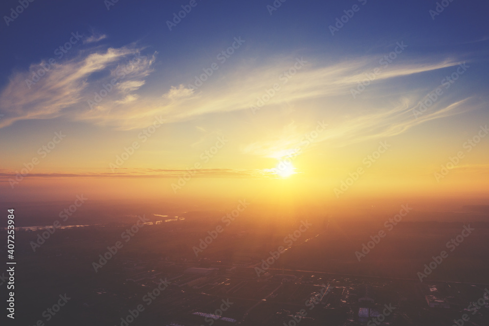 Colorful cloudy sky at sunset. Sky texture abstract nature background. Aerial view of the countryside in the foggy evening