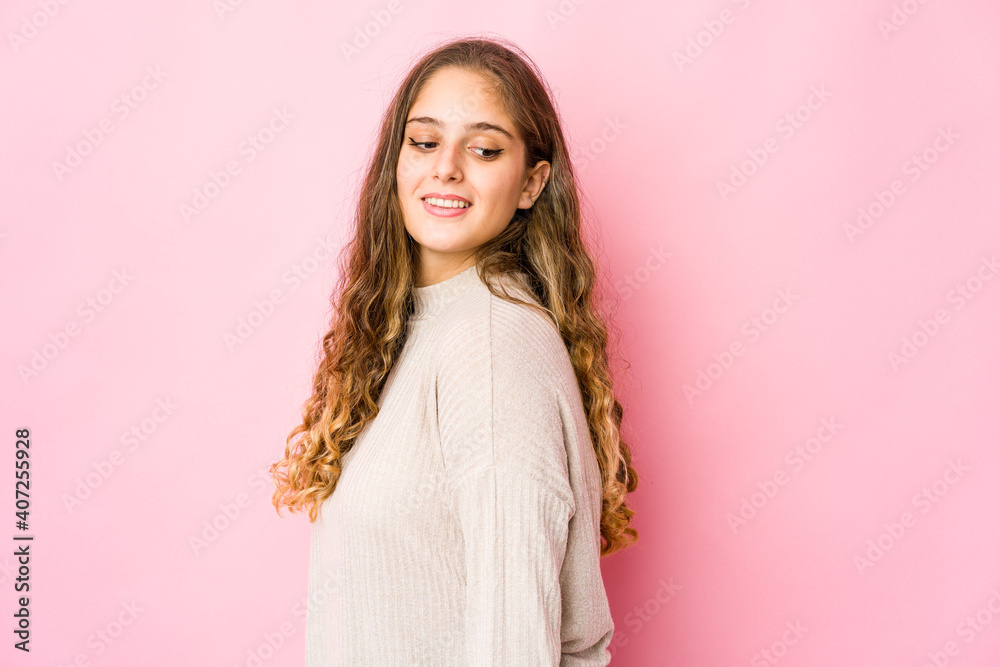 Young caucasian woman looks aside smiling, cheerful and pleasant. Young caucasian woman looks aside smiling, cheerful and pleasant.
