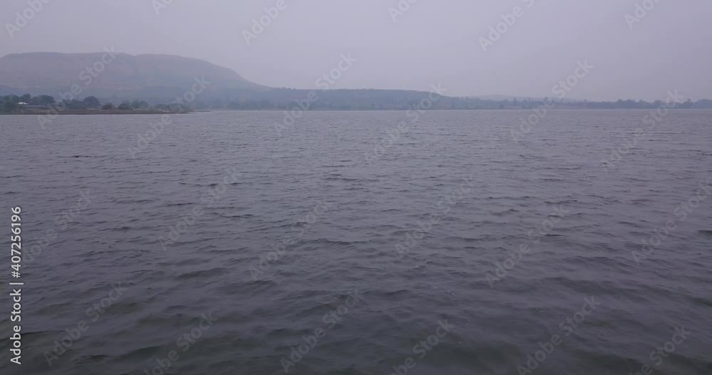 Beautiful calm waves of Trimbakeshwar, India on a cloudy day -low aerial Beautiful calm waves of Trimbakeshwar, India on a cloudy day -low aerial