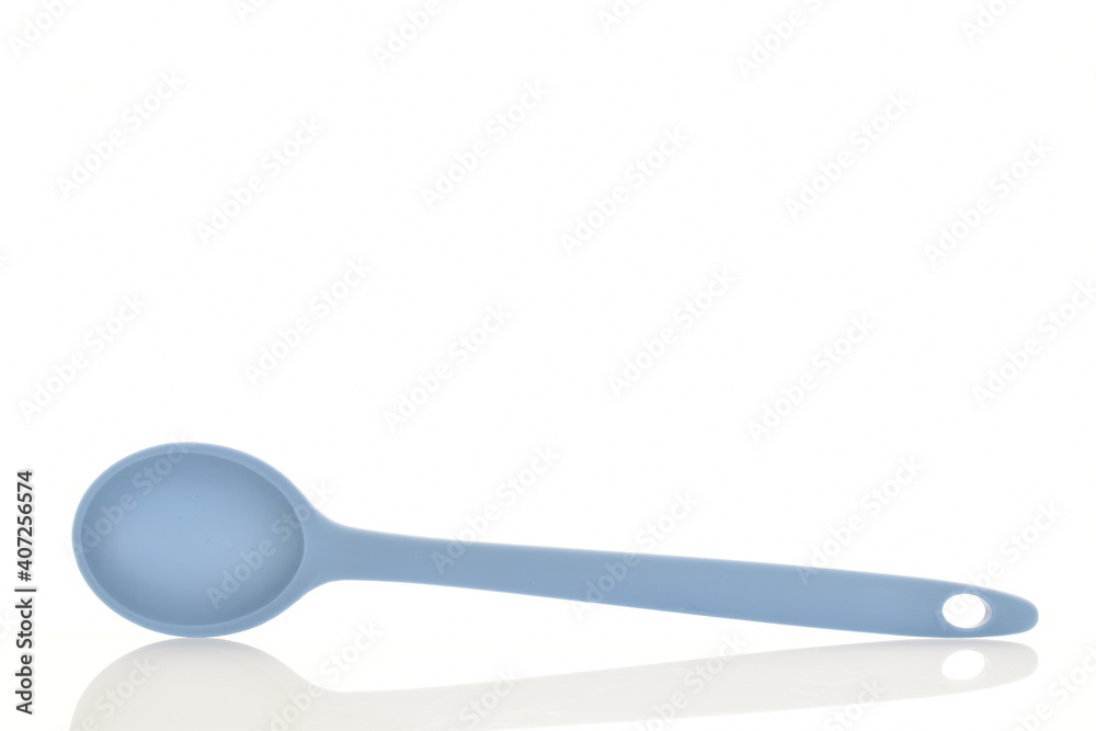 One silicone blue spoon, for the kitchen, close-up, isolated on white. One silicone blue spoon, for the kitchen, close-up, isolated on white.