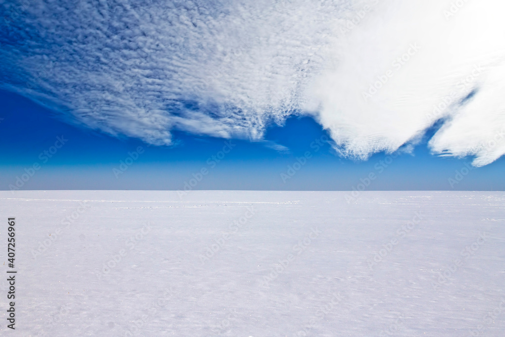 Snow field and cloudy sky