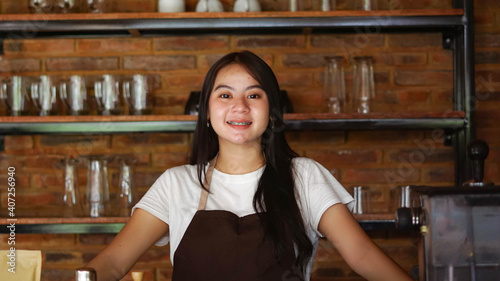 Asian woman barista smilling look camera at cafe