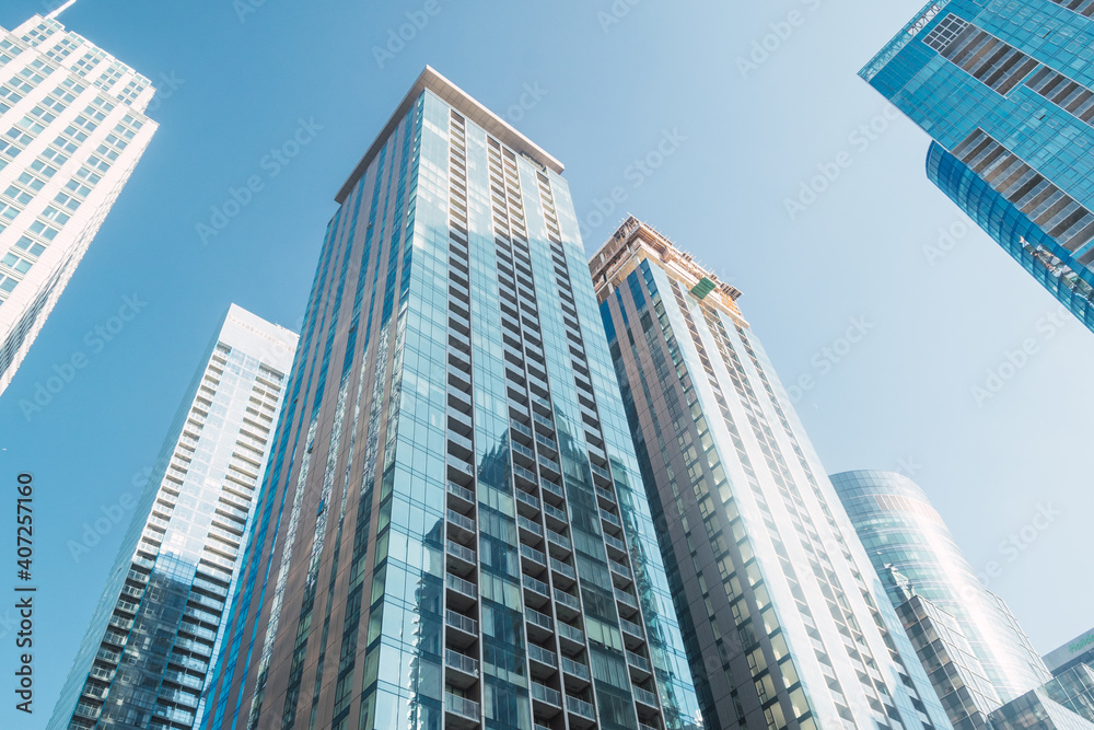 View from below of tall blue skyscrapers in the city of Montreal