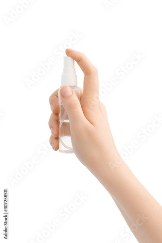 Woman holds alcohol-based hand-washing spray as a preventive hygiene measure against coronavirus.