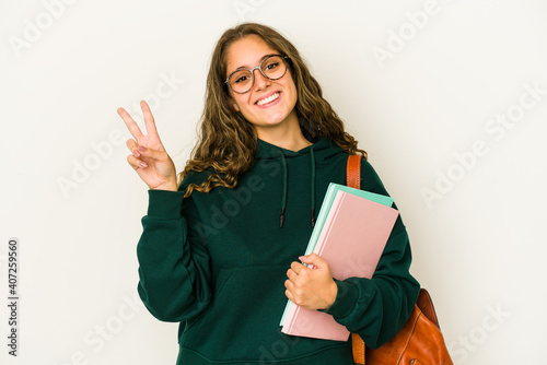 Obraz na plátně Young caucasian student woman isolated joyful and carefree showing a peace symbol with fingers