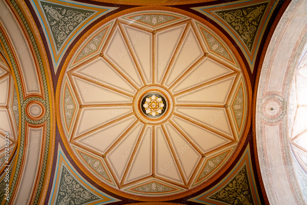 Symmetrical decorated interior ceiling in old building
