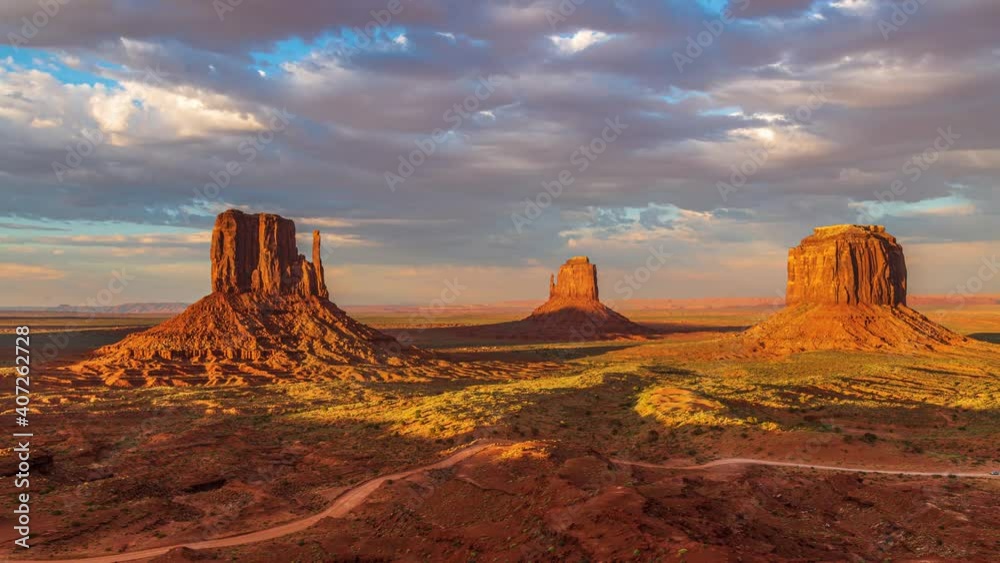 Beautiful orange and pink sunset timelapse with unique geological rock formations and clouds flowing in Monument Valley, Arizona United States Beautiful orange and pink sunset timelapse with unique geological rock formations and clouds flowing in Monument Valley, Arizona United States
