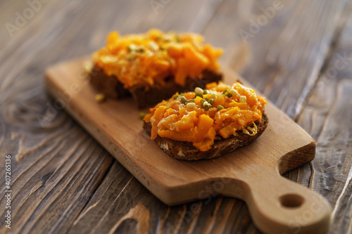 Delicious baked pumpkin sandwiches with cheese, sesame seeds and sprouted beans
