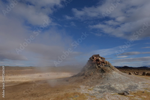 Steam geyser on Icelandic meadow