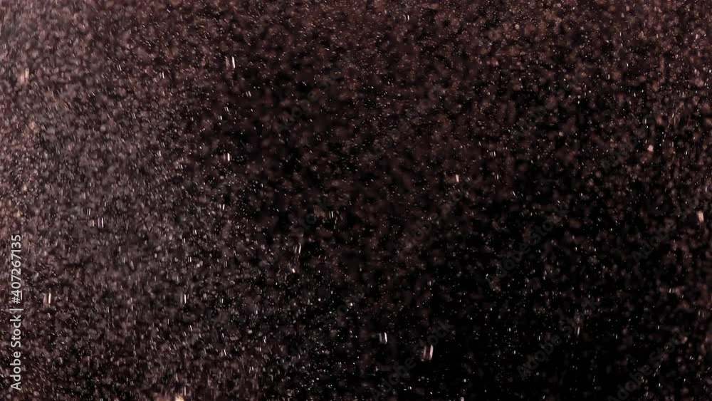 A bubbles rise upwards in boiling water in an electric kettle with transparent walls, close up.