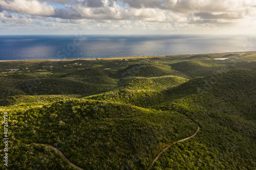 Aerial view above scenery of Curacao  Caribbean with ocean  coast  hills  lake