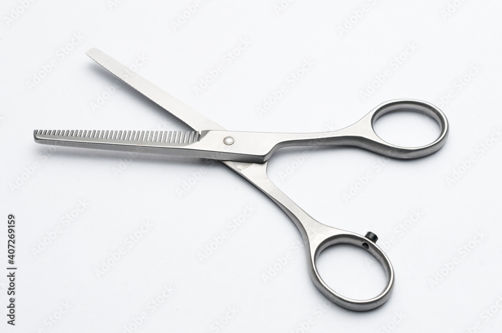Pair of hair thinning scissors on white background Pair of hair thinning scissors on white background