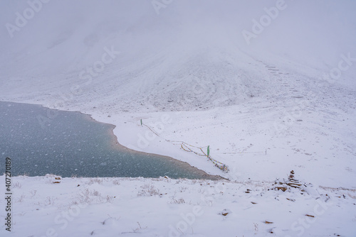 Snowy Chandratal or Lake of the moon is a high altitude lake located at 4300m in Himalayas of Spiti Valley, Himachal Pradesh, India. The name of Lake originated due to its crescent moon like shape. photo