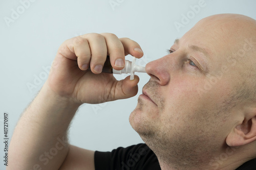 Fototapeta Naklejka Na Ścianę i Meble -  man buries the medicine in his nose.