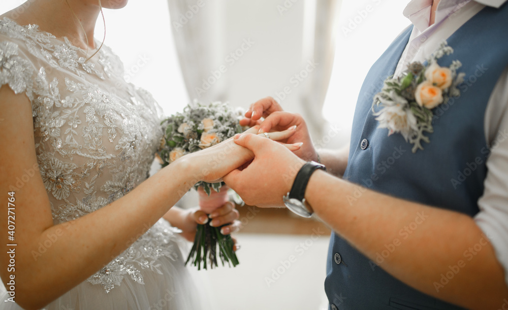 The man puts the ring on the bride. The man puts the ring on the bride.