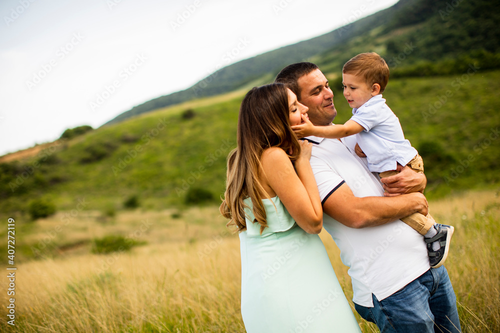 Young family having fun outdoors in the field Young family having fun outdoors in the field