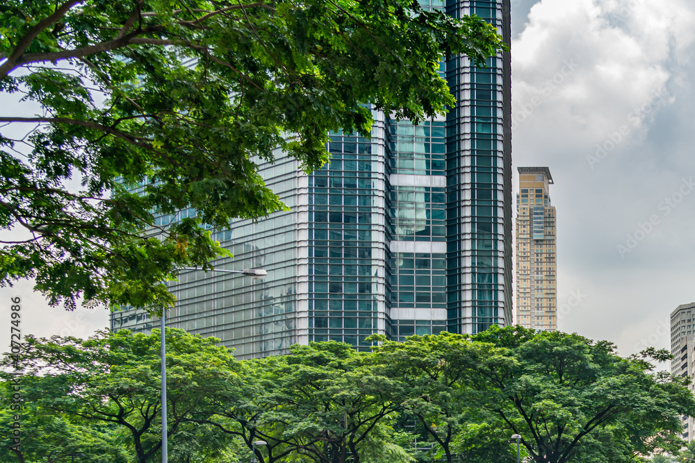 Futuristic financial tower and trees at the park outside building
