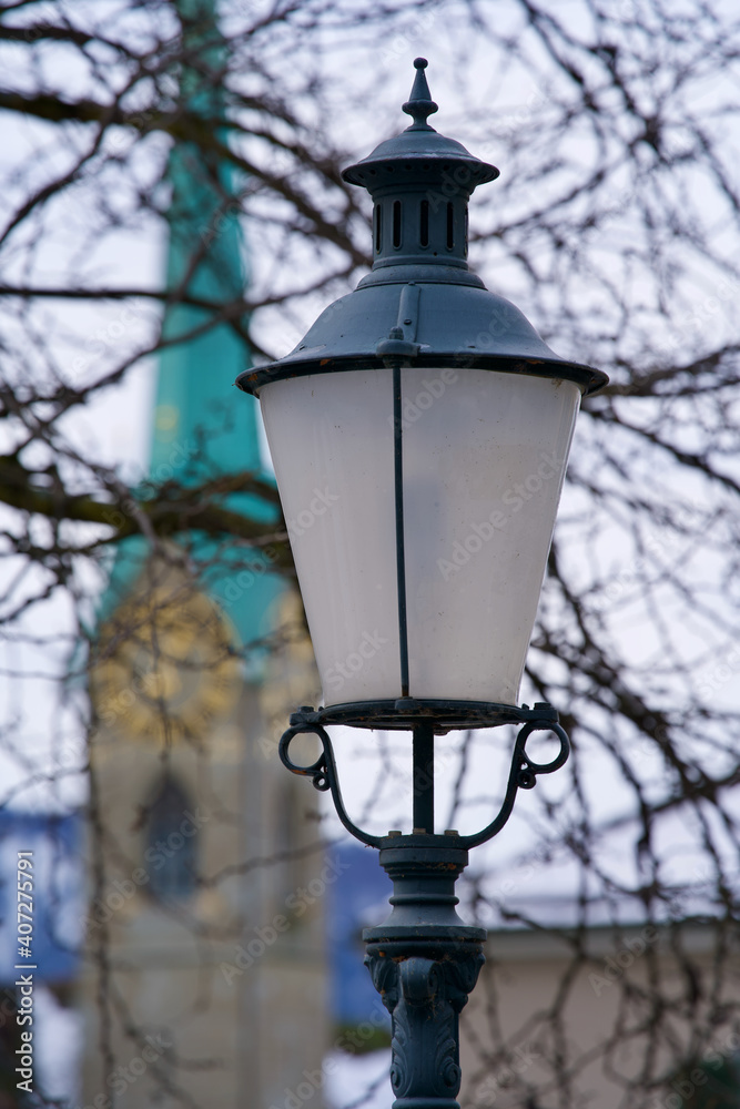 Vintage street lamp with church in the background. Old town of Zurich, Switzerland.