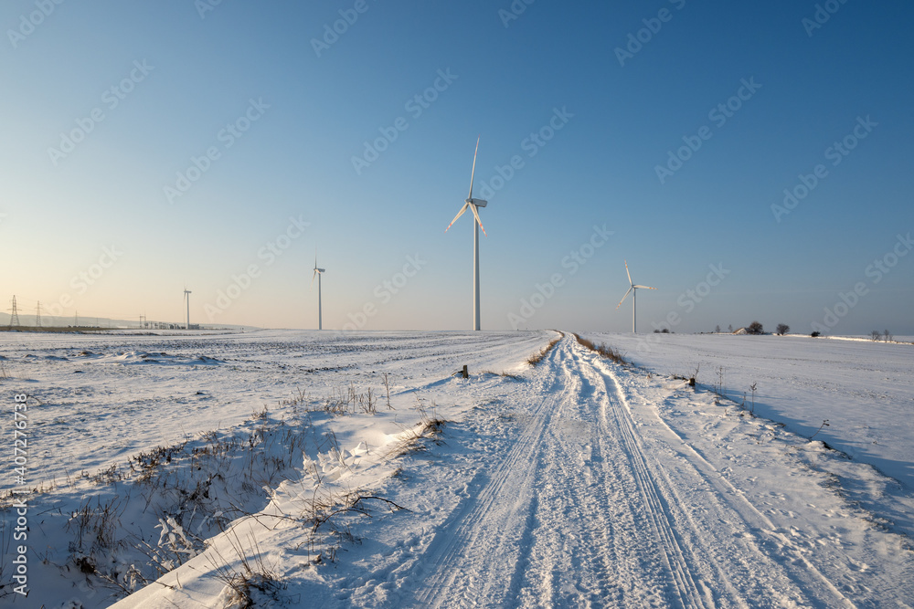 Snow covered field road. Winter landscape in northern Poland. Europe