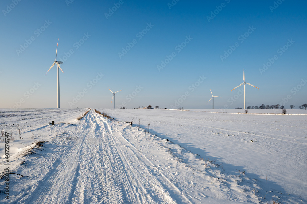 Snow covered field road. Winter landscape in northern Poland. Europe Snow covered field road. Winter landscape in northern Poland. Europe