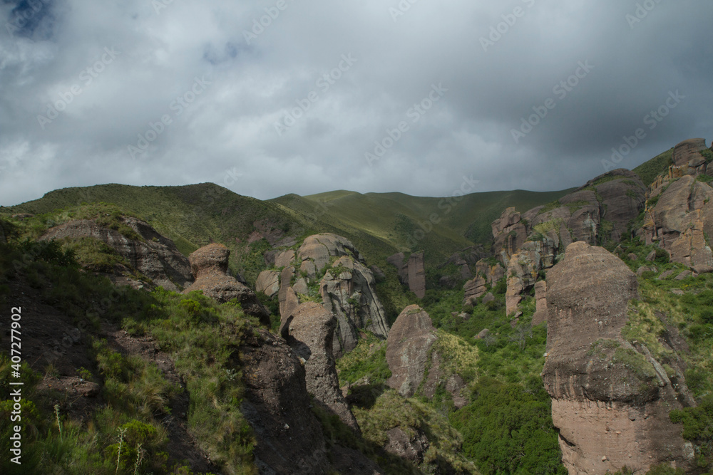 Alpine landscape. Panorama view of the mountains, green forest and rock formations called Los Terrones, in Cordoba, Argentina.