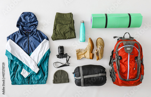 Equipment for hiking on light background photo