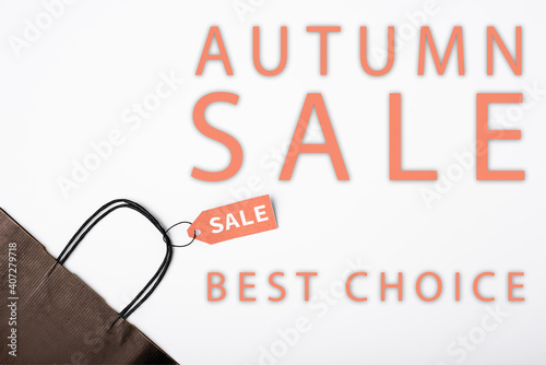 Top view of price tag on shopping bag near autumn sale, best choice lettering on white background