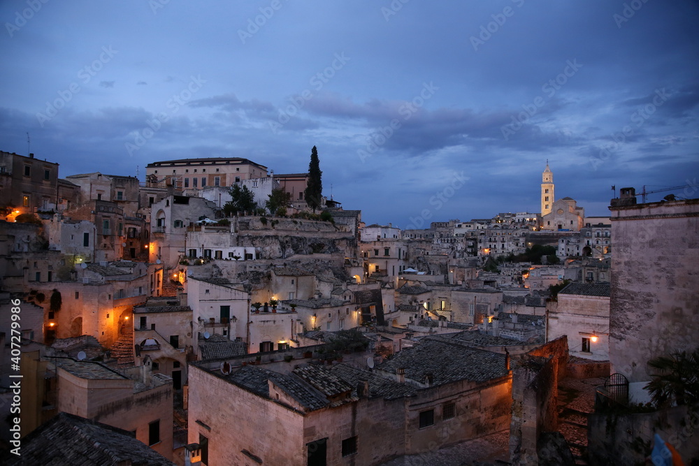 Night view of the houses and illuminated streets of Sasso Barisano, district of Matera, European Capital of Culture 2019