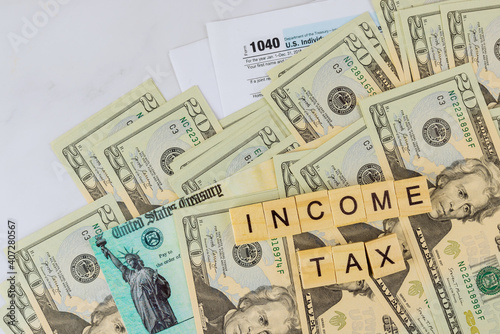 IRS form 1040 with individual income tax return of dollar bills of Stimulus economic tax return check