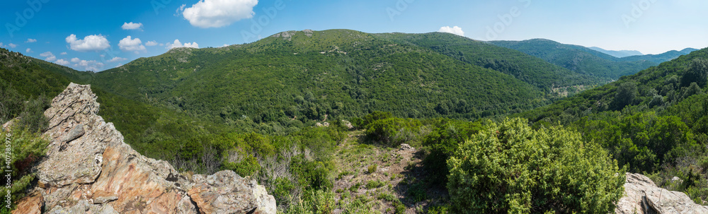 Panoramic view from white limestone tower Perda Liana, impressive rock boulders, green forest hill and mountain. National Park of Barbagia, Central Sardinia, Italy, summer day. Panoramic view from white limestone tower Perda Liana, impressive rock boulders, green forest hill and mountain. National Park of Barbagia, Central Sardinia, Italy, summer day.