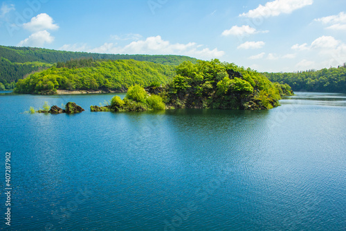 Lake Urft at Eifel National Park, Germany. Scenic view of lake and river Urft and surrounded lush green landscape in North Rhine-Westphalia photo