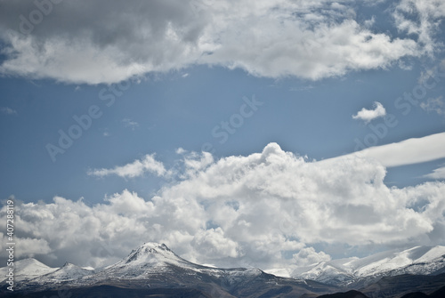 Clouds have accumulated on beautiful snow-capped mountains