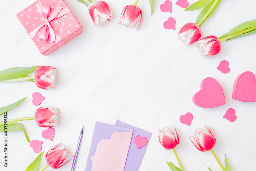 Obraz premium Flat lay valentines day frame with pink tulips and gift box on a white background
